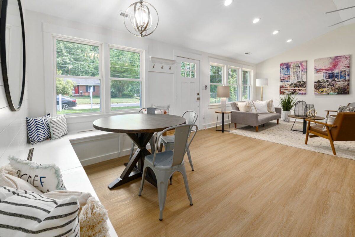 Bright and spacious modern living room showcasing elegant interior design with wooden floors and stylish furniture.
