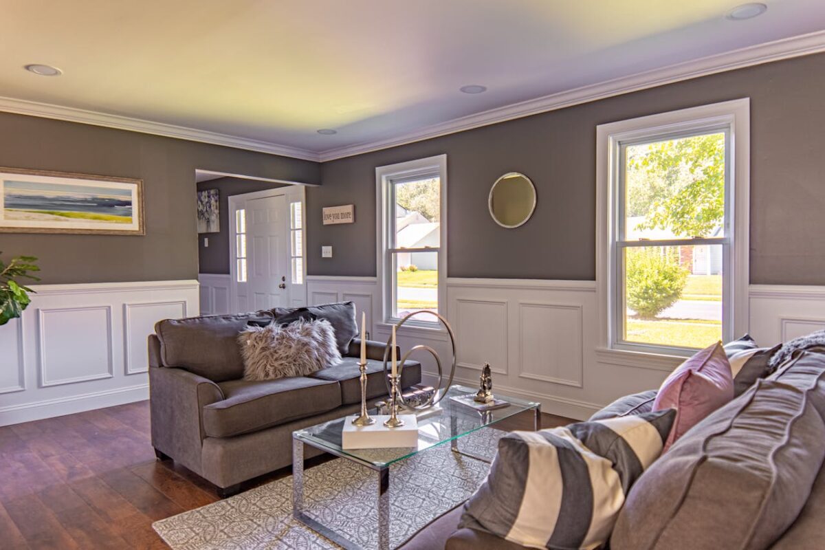 Inviting modern living room with gray sofas, coffee table, and natural light.
